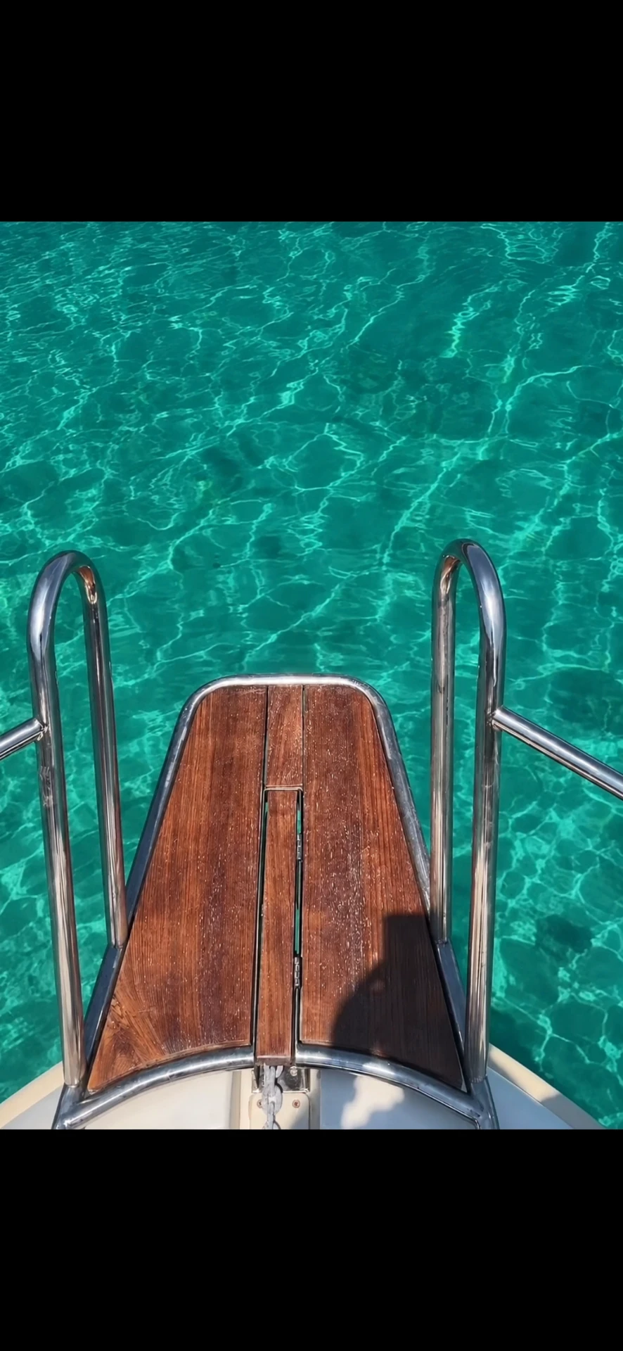 Teak swim platform above turquoise Adriatic water